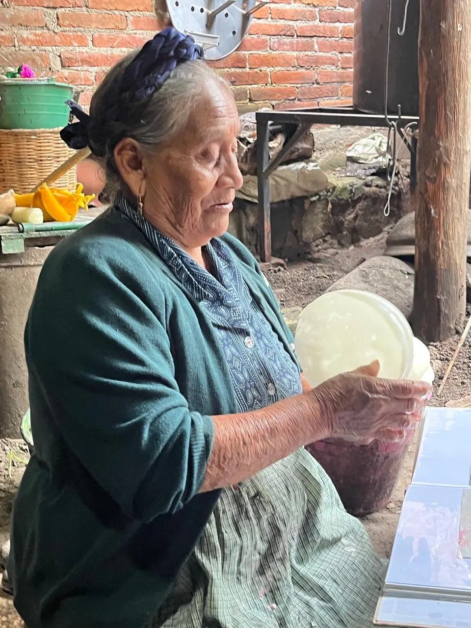 A Teotitlán artisan preparing wool by hand