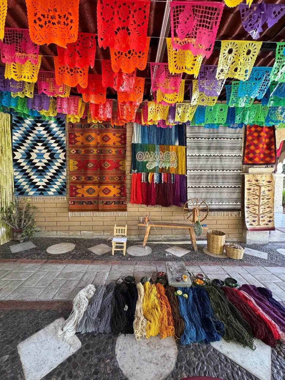 Rugs, wool and papel picado in a weaving workshop of Teotitlán